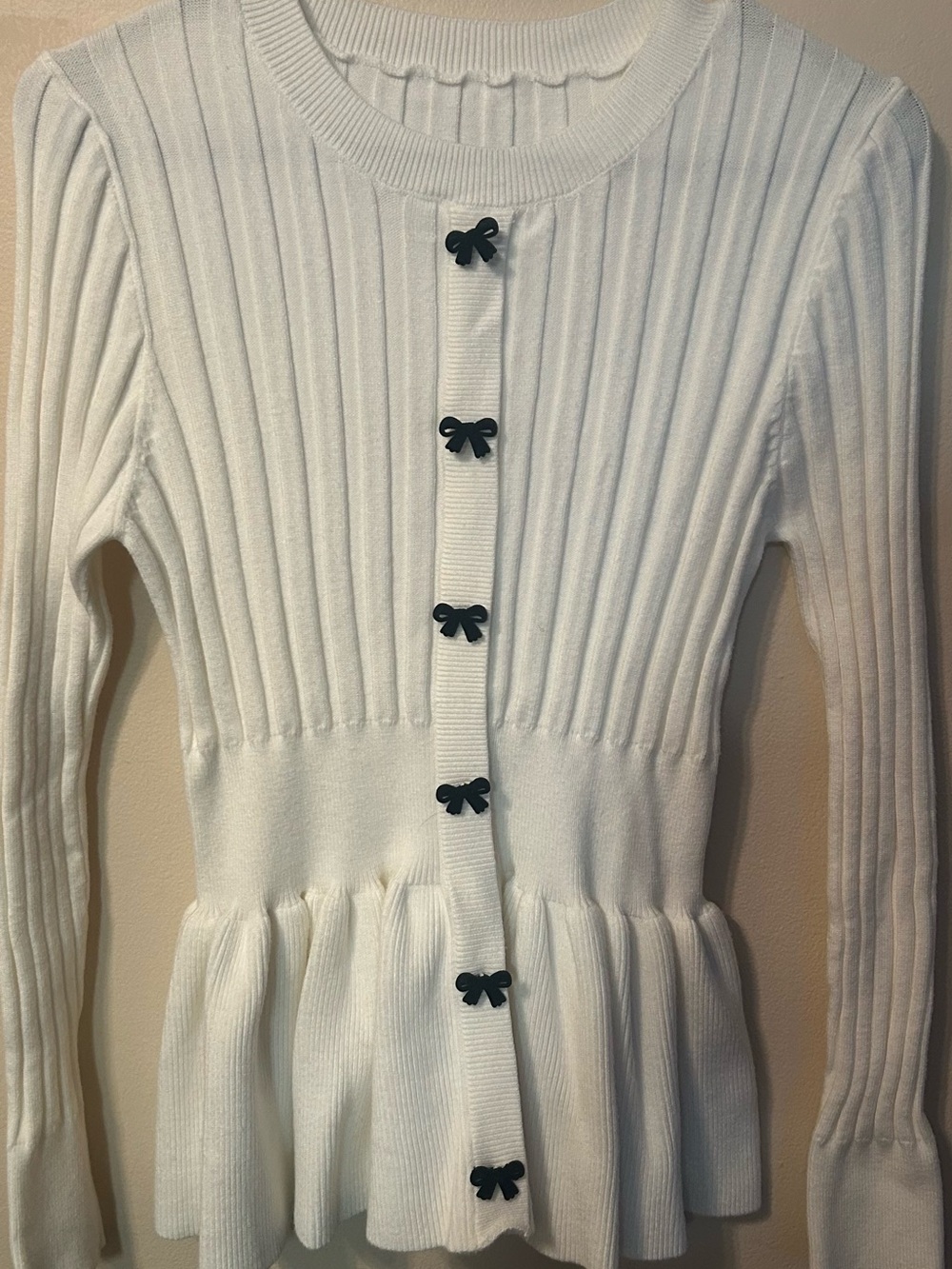 Women’s White Ribbed Peplum Cardigan with Black Bow Buttons